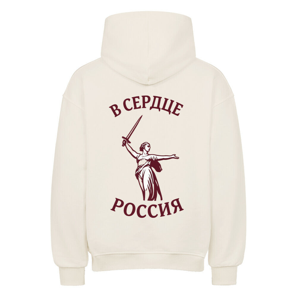 Grauer oversized Hoodie von Pelasgia mit Russland-Design und Heimat & Herz Stickerei, bequeme Passform, lässiges Streetwear-Outfit