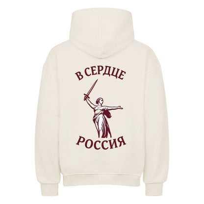 Grauer oversized Hoodie von Pelasgia mit Russland-Design und Heimat & Herz Stickerei, bequeme Passform, lässiges Streetwear-Outfit